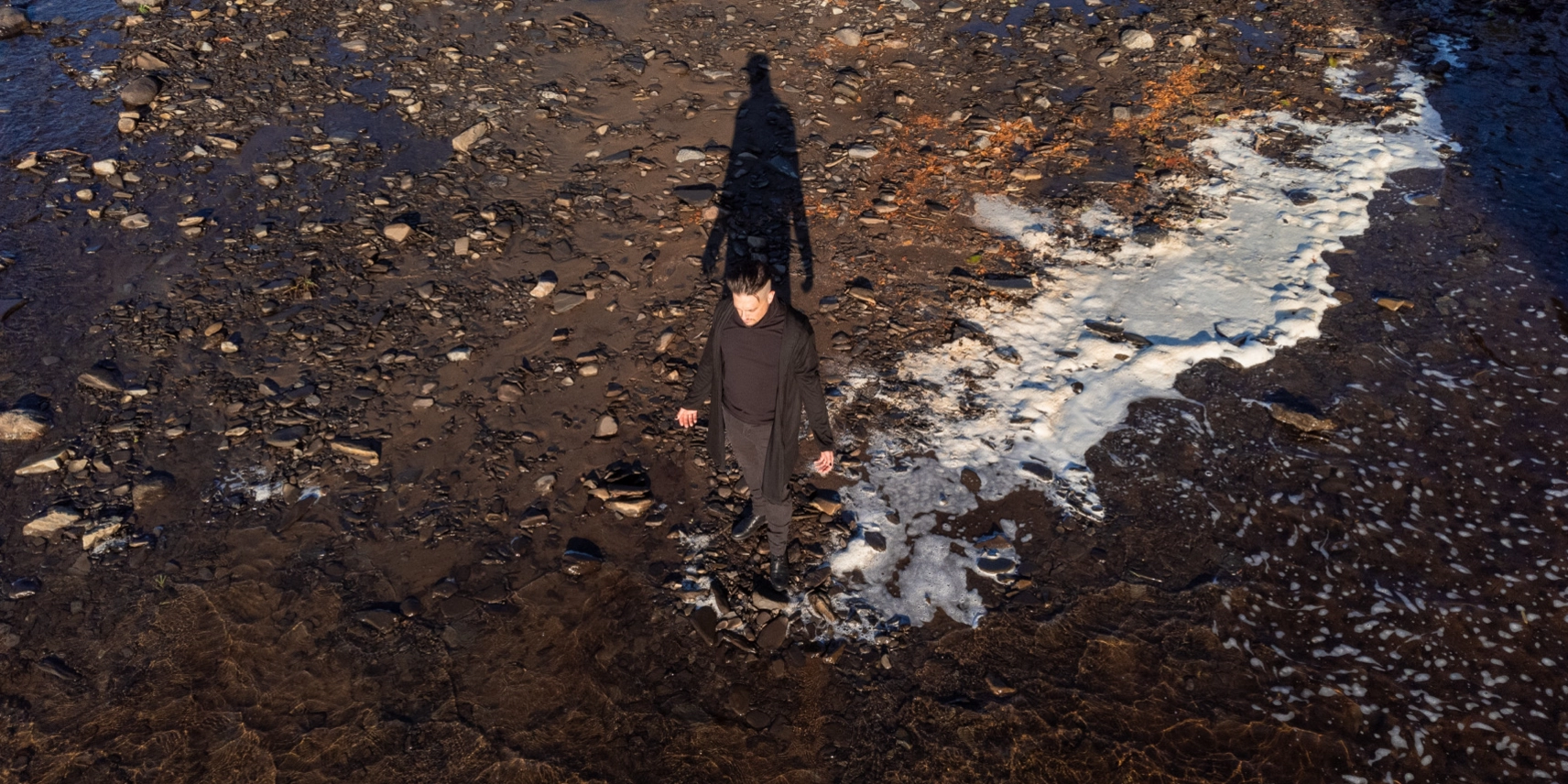 Photo de drone de David au bord d'une rivière